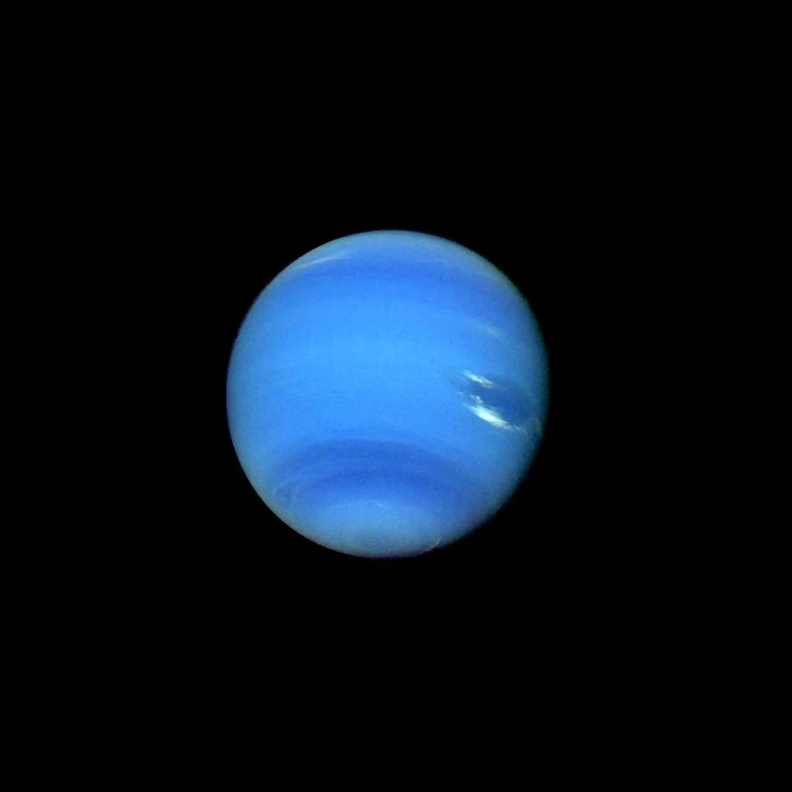 A bright blue planet against a black background.