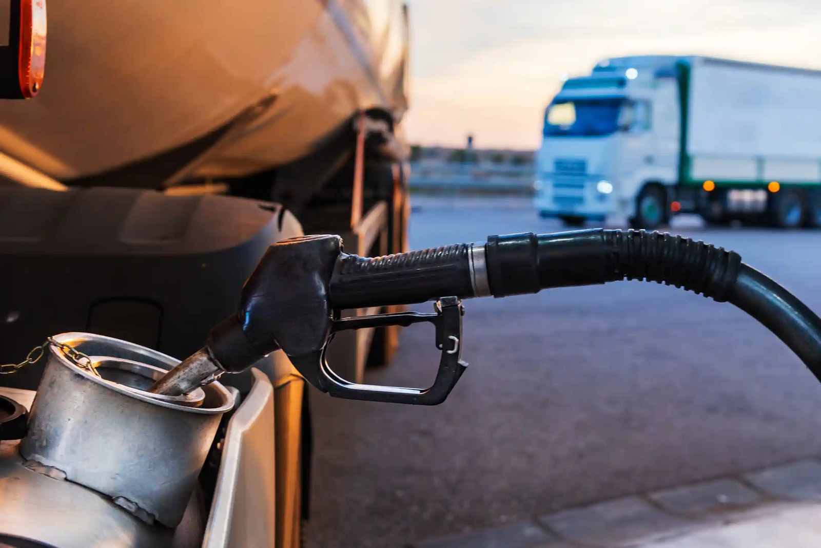 Diesel nozzle from a petrol station filling a truck tank.