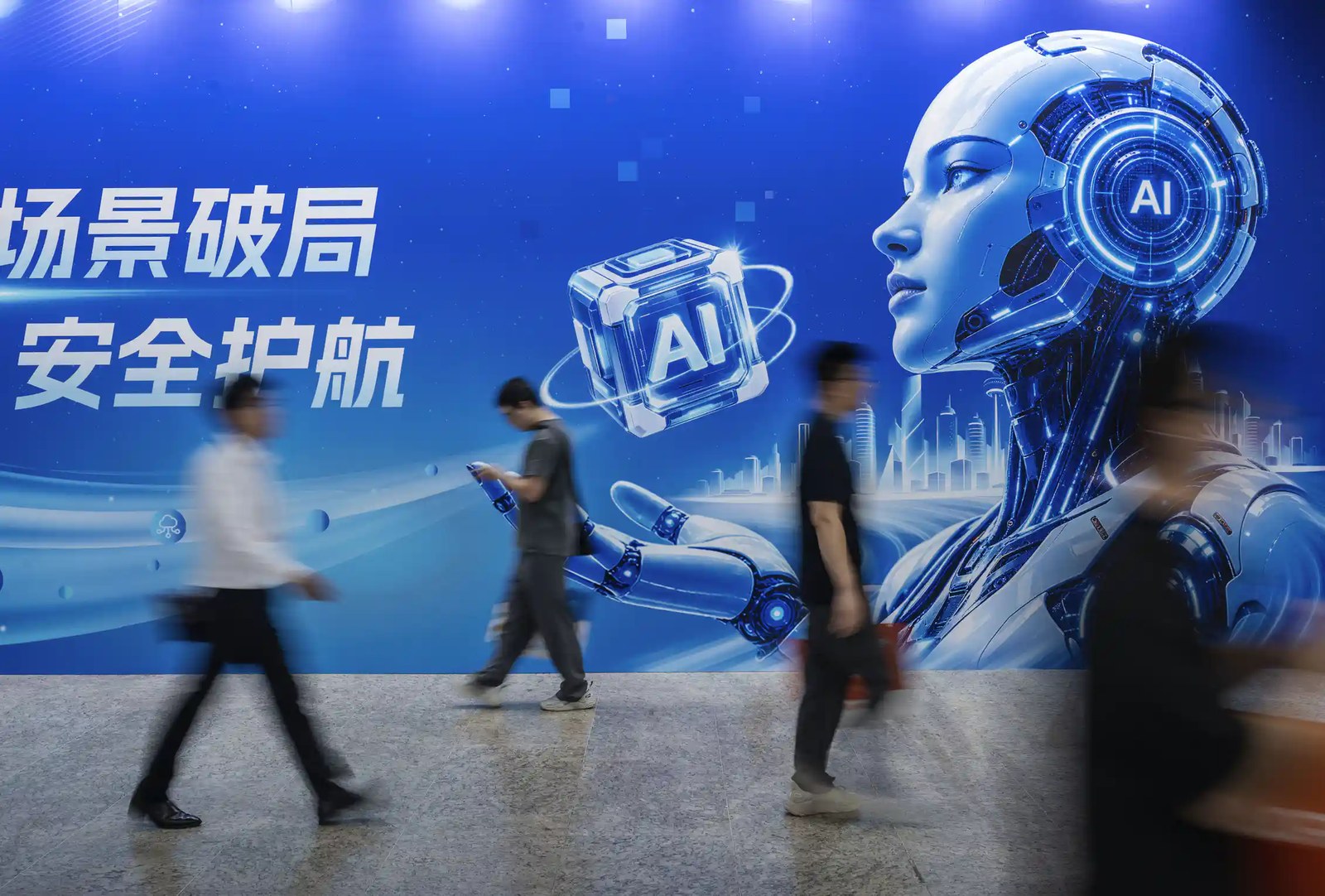 Several people walk by a billboard and a robot depicted on it.