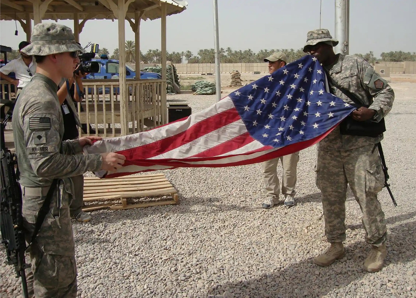 US soldiers in Iraq fold a flag