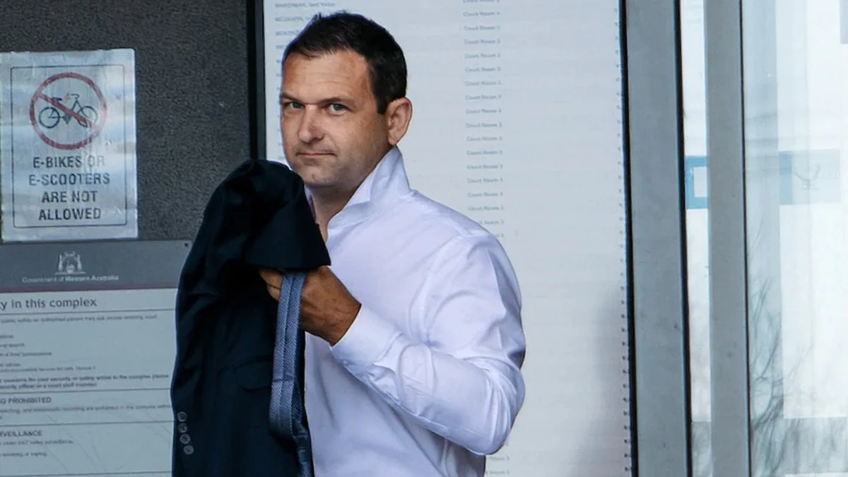 man in white shirt leaves court building