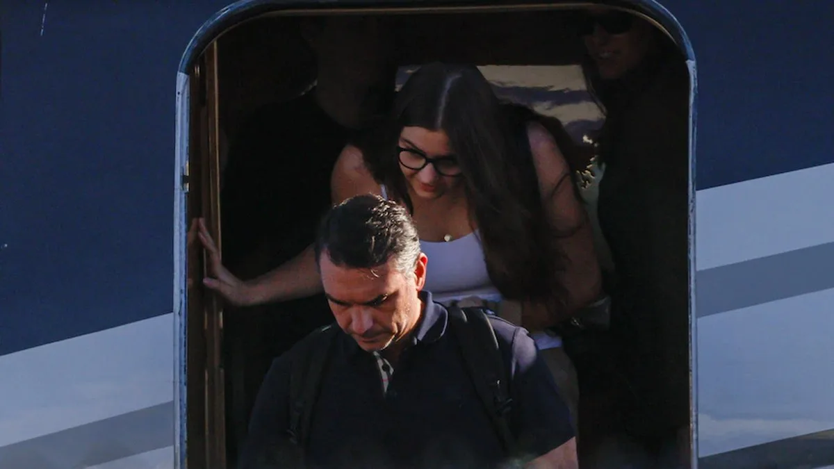 Flavio Bolsonaro and a woman disembarking from a plane.