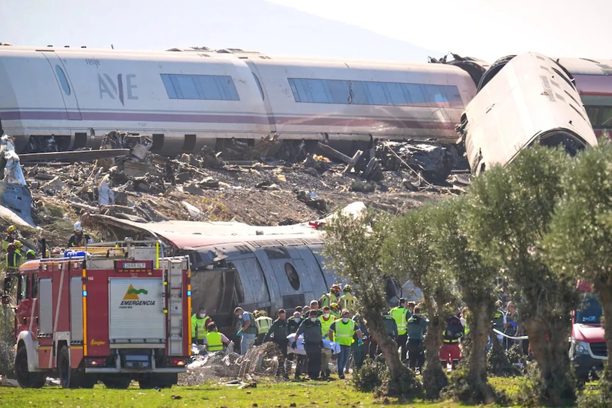 a train crash with emergency crews arround in, part of it is derailed.