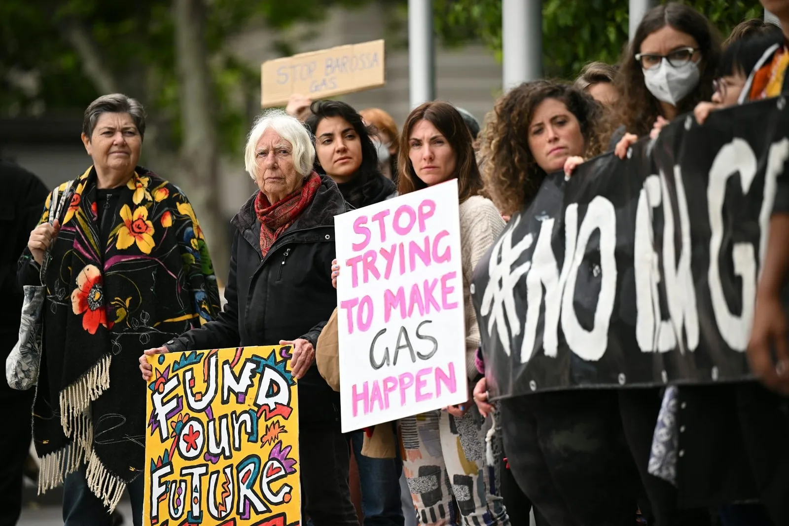 People gather outside the Federal Court of Australia in Melbourne in November 2022, protesting Santos’s appeal to proceed with a massive gas project in the Northern Territory. James Ross/AAP