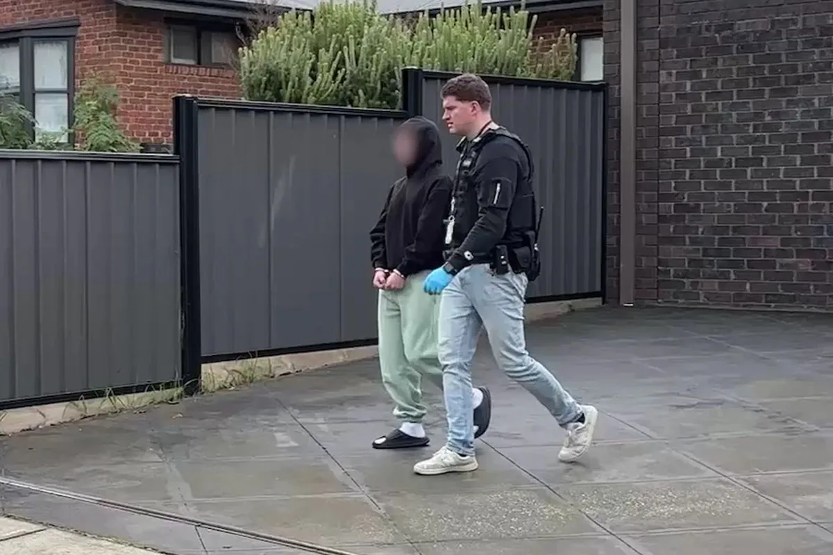 A police officer arresting a man