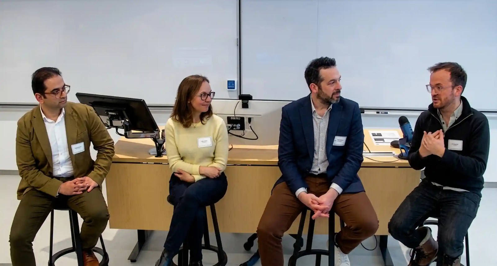 Four people talking at a roundtable