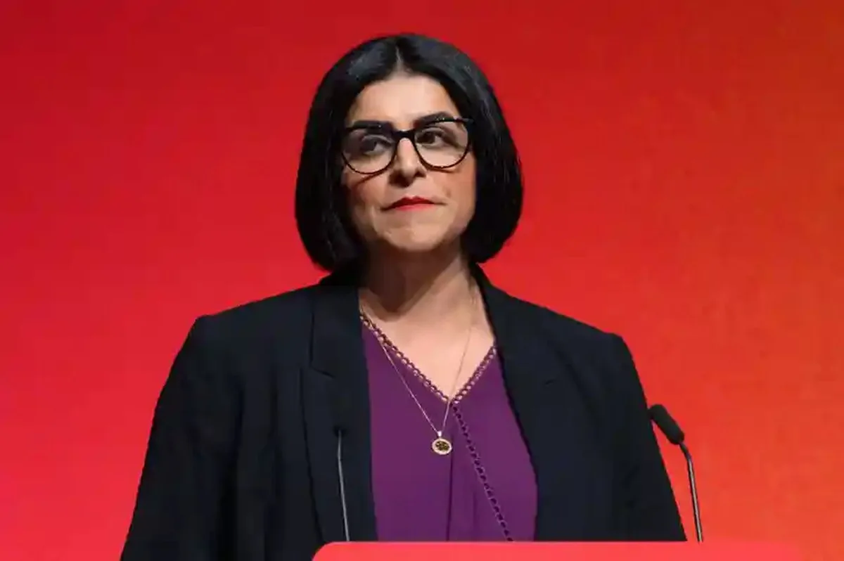 Shabana Mahmood MP speaks at a podium against a red background at a conference