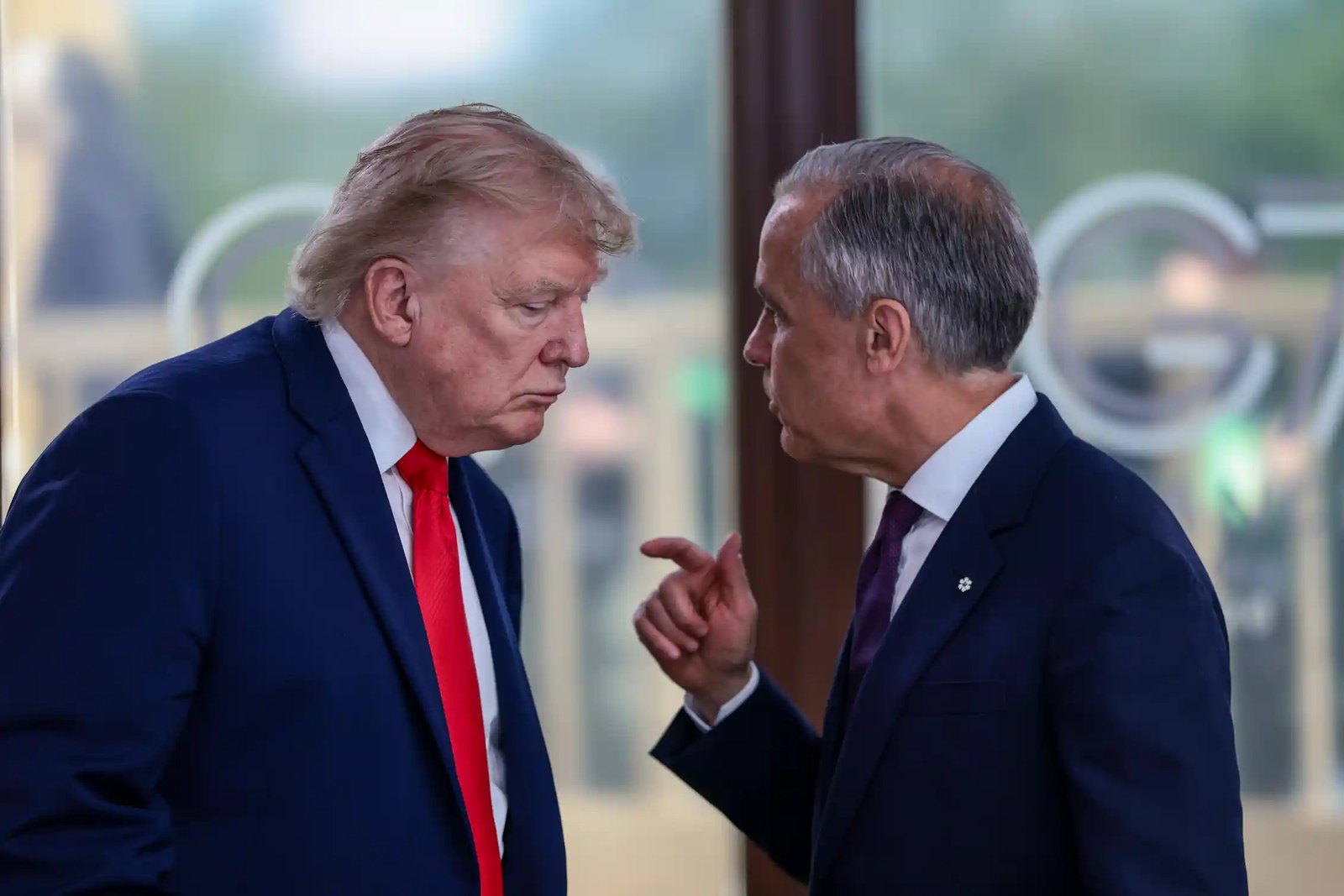 Two white men in suits having a conversation