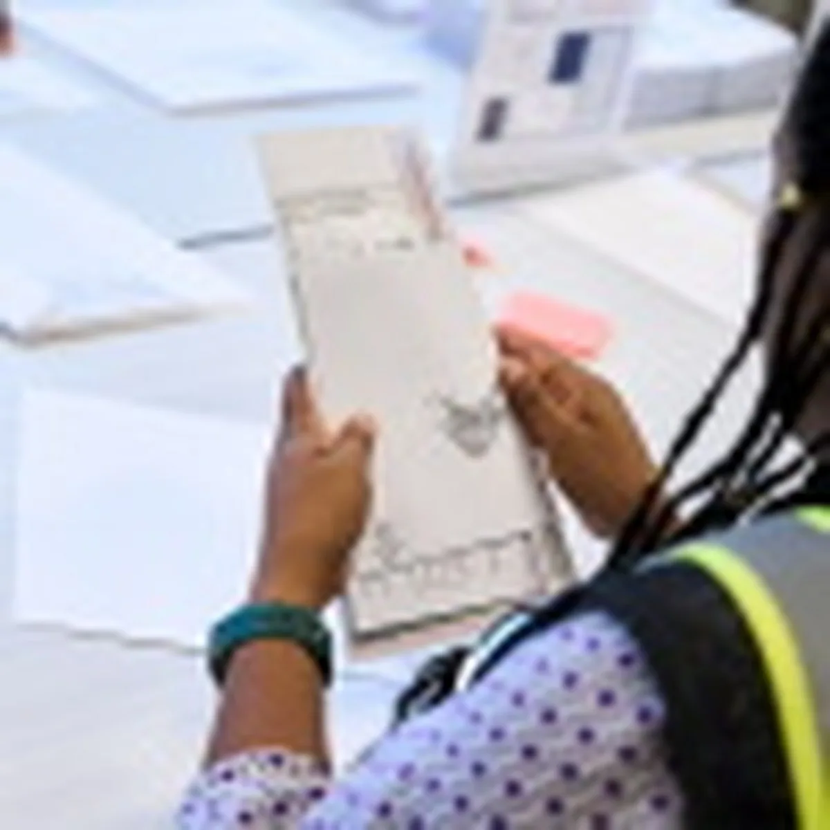 A Wake County Board of Elections employee prepares a mail-in ballot to be sent out to a voter in September in Raleigh, N.C.