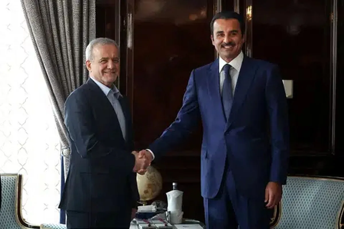 Iranian President Masoud Pezeshkian shakes hands with Qatar's Emir Sheikh Tamim bin Hamad Al Thani as they meet in Moscow, Russia, October 27, 2026. Iran's Presidential website/WANA (West Asia News Agency)/Handout via REUTERS