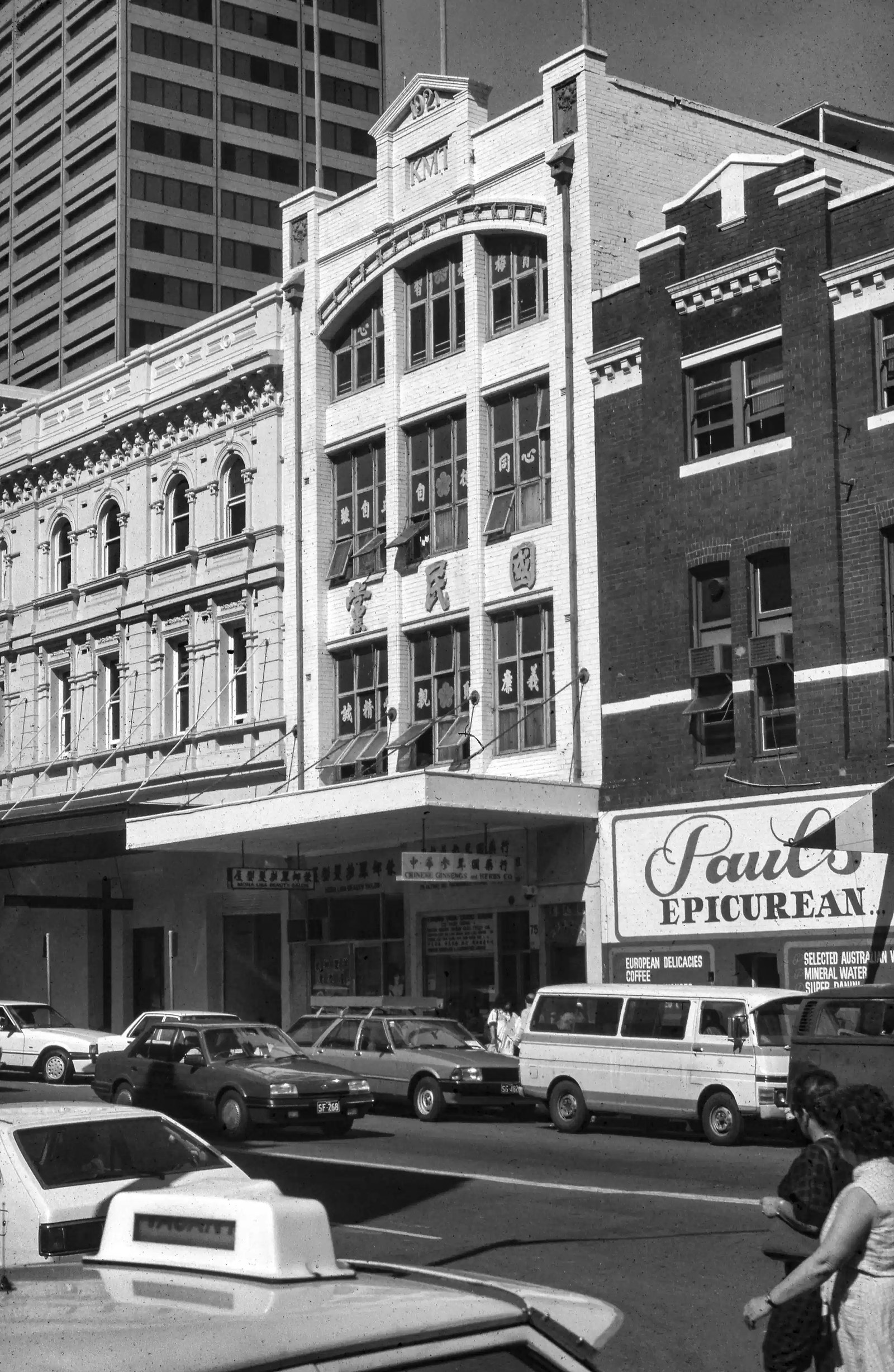 View south east of Chinese Nationalist Party of Australia (Kuomintang or KMT) building at 75-77 Ultimo Road, Haymarket. On left hand side is Mountbatten Hotel at number 79. On right hand side is Paul's Epicurean shop at number 73. In foreground are traffi