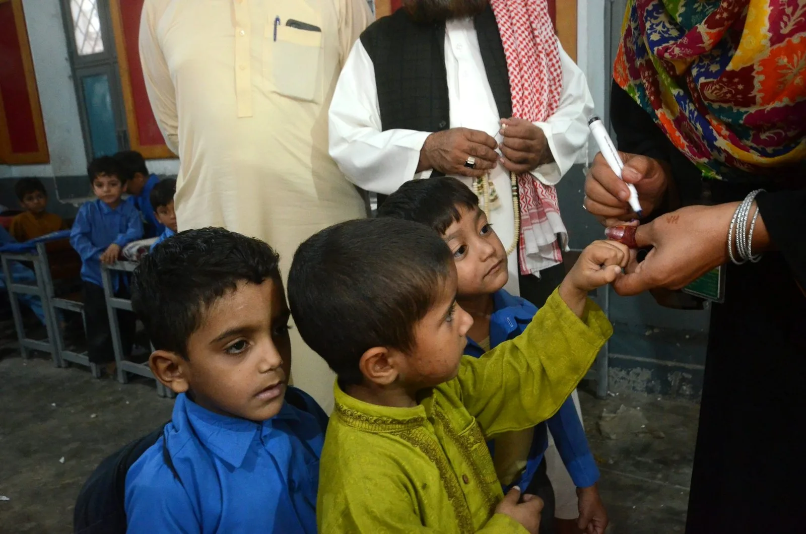 A Pakistani health worker marks the pinkie of a child she has just vaccinated for polio. Pacific Press/LightRocket via Getty Images