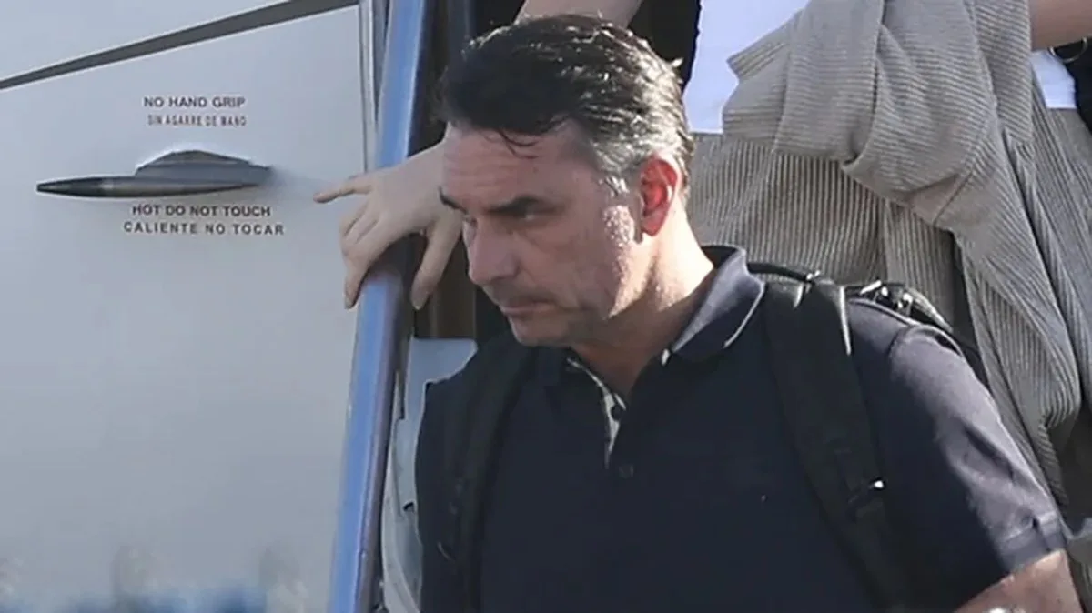 Flavio Bolsonaro steps off a plane after arriving at Opa Locka Executive Airport in Miami - GETTY