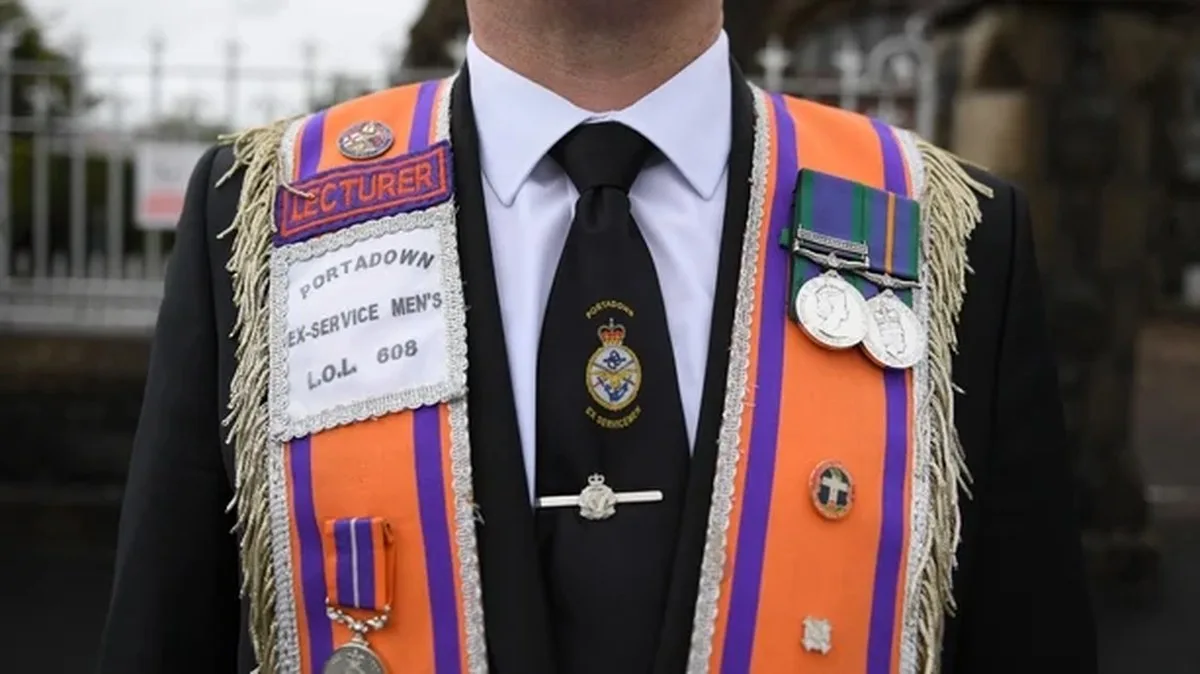 A member of the Orange Order stands outside Drumcree Church in Portadown