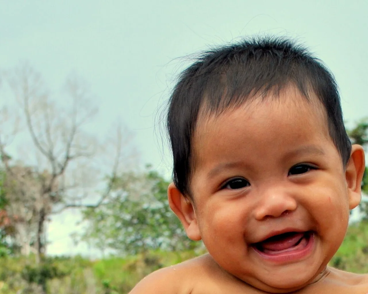 Smiling begins in infants at a young age, progressing into social smiling, and becoming more intentional as they grow older